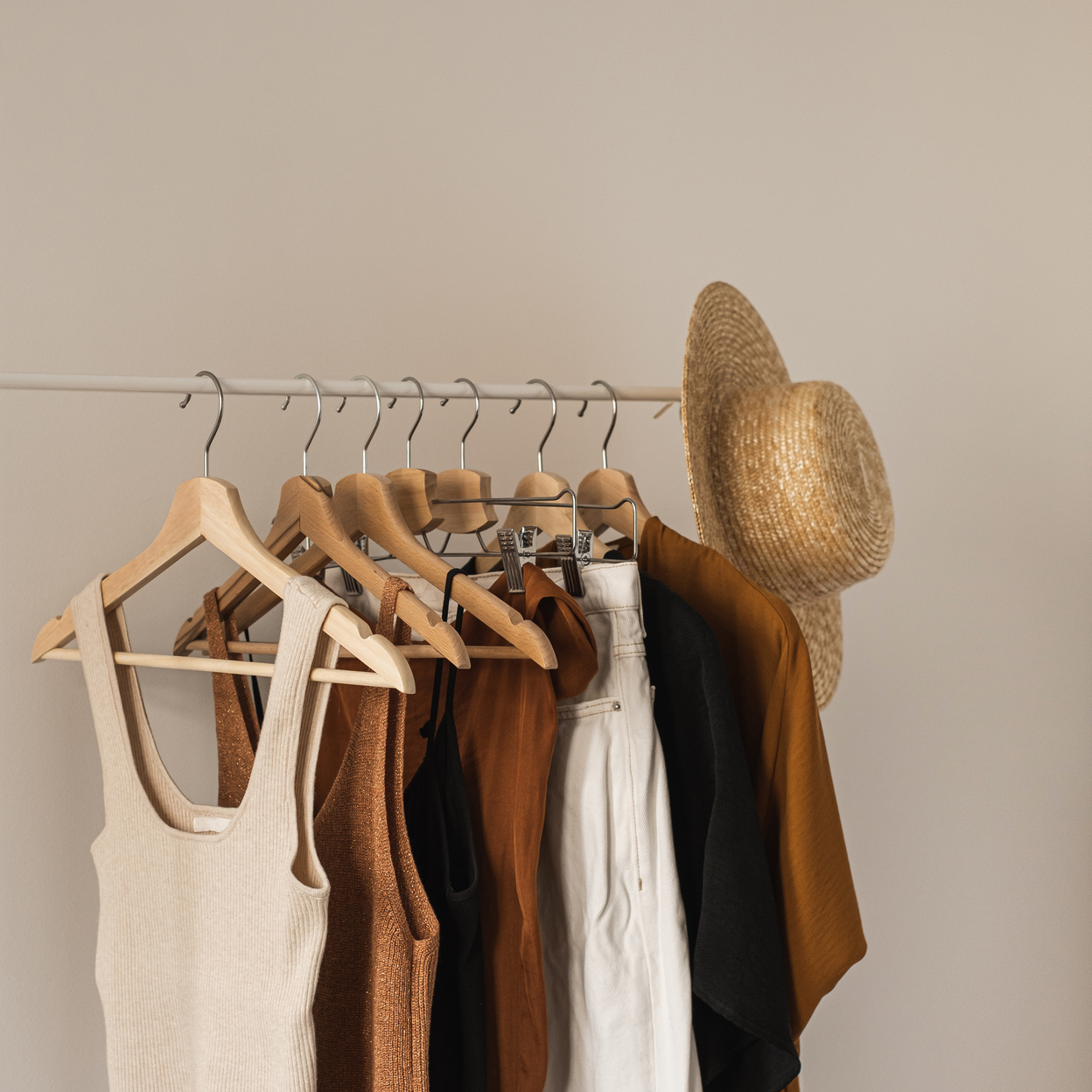 Clothes and a Straw Hat Hanging on a Rack